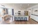 Bright kitchen with white cabinets, stainless steel appliances, large kitchen island with seating and granite countertops at 7824 Gray Eagle Dr, Zionsville, IN 46077