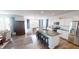Open-concept kitchen with a large island, stainless steel appliances, and hardwood floors at 7824 Gray Eagle Dr, Zionsville, IN 46077