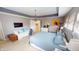 Spacious main bedroom featuring a tray ceiling, chandelier, and plush bedding at 7824 Gray Eagle Dr, Zionsville, IN 46077