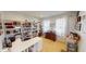 Functional home office with bookshelves, a desk, and natural light from the windows at 7824 Gray Eagle Dr, Zionsville, IN 46077