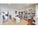Bright home office with bookshelves, a desk, and glass doors leading to the living room at 7824 Gray Eagle Dr, Zionsville, IN 46077