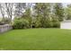 Beautifully landscaped backyard featuring lush green grass and a wooded border providing great privacy at 7950 Westfield Blvd, Indianapolis, IN 46240