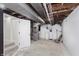 Utility area in basement with water heater, mechanicals, and stairs to the upper level at 7950 Westfield Blvd, Indianapolis, IN 46240