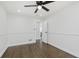 Bright bedroom featuring beautiful hardwood floors, ceiling fan, with an entry door leading to the hallway at 7950 Westfield Blvd, Indianapolis, IN 46240