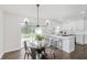 Bright dining area with modern light fixture, seats four, and sliding door access to backyard at 7950 Westfield Blvd, Indianapolis, IN 46240