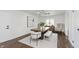 Bright dining room with modern chandelier, sleek furniture, large art, and natural light at 7950 Westfield Blvd, Indianapolis, IN 46240