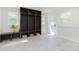 Mud room with shelving, storage bench, tile floor and white door at 7950 Westfield Blvd, Indianapolis, IN 46240
