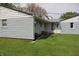 Lush backyard with an outbuilding featuring light blue siding and mature trees in the background at 8341 N Washington St, Sheridan, IN 46069