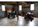 Unfinished basement with two windows and features a four-wheeler and lawn tractor at 8341 N Washington St, Sheridan, IN 46069