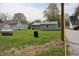 Backyard view with a large, lush green yard and a few outbuildings including a metal propane tank at 8341 N Washington St, Sheridan, IN 46069