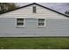 Side of a house with light blue siding, white trim, two windows, and a well-maintained lawn at 8341 N Washington St, Sheridan, IN 46069