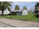 Quaint single-story home with a light blue exterior and a well-manicured lawn at 8341 N Washington St, Sheridan, IN 46069