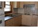 Classic kitchen featuring a double sink, ample cabinet space, and tile backsplash at 8341 N Washington St, Sheridan, IN 46069