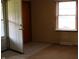 This living room features neutral walls, carpeted and tiled flooring, and a window for natural light at 8341 N Washington St, Sheridan, IN 46069