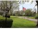 Picture of the front yard of a house with a tree and an American flag in the background at 8341 N Washington St, Sheridan, IN 46069