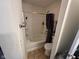Bathroom with a tub and shower combination, tiled walls, and essential fixtures at 8409 Bolero Way, Camby, IN 46113