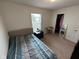 Bedroom featuring carpeted floors, a window, and a bed with a patterned comforter at 8409 Bolero Way, Camby, IN 46113