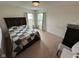 Carpeted bedroom featuring a bed with a patterned quilt and two windows for natural light at 8409 Bolero Way, Camby, IN 46113