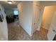 Bright entryway leading to the living room and bathroom featuring modern flooring and neutral walls at 8409 Bolero Way, Camby, IN 46113