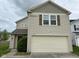 Charming home featuring a two-car garage, warm siding, and classic shuttered windows at 8409 Bolero Way, Camby, IN 46113