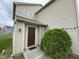 A close-up of the front door, framed by lush greenery, welcomes you home at 8409 Bolero Way, Camby, IN 46113