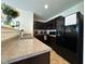 Efficient kitchen featuring dark cabinets, modern appliances, and ample counter space at 8409 Bolero Way, Camby, IN 46113