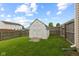 Enclosed backyard showcasing a small storage shed, with privacy fencing and a view of neighboring homes at 901 Palomino Pl, Bargersville, IN 46106