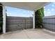 A fenced in backyard with a covered patio and plenty of privacy trees at 901 Palomino Pl, Bargersville, IN 46106