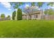 Green backyard featuring manicured lawn, shade trees, partial fencing, and the home's rear facade at 901 Palomino Pl, Bargersville, IN 46106