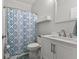 Bathroom featuring a shower/tub combo with blue patterned curtain, single vanity, and a tile floor at 901 Palomino Pl, Bargersville, IN 46106