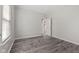 An empty bedroom with fresh paint, modern ceiling fan, and new vinyl floors and natural light at 901 Palomino Pl, Bargersville, IN 46106