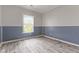 Bedroom with wainscoting, LVP flooring and a bright window at 901 Palomino Pl, Bargersville, IN 46106