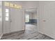 Bright entryway with gray wood-look flooring, white walls, and a view of a blue accent wall at 901 Palomino Pl, Bargersville, IN 46106