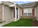 Inviting front entrance with red accents, manicured lawn, and natural light from the window at 901 Palomino Pl, Bargersville, IN 46106