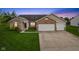 Charming single-story home with brick accents, two-car garage, and well-manicured lawn at 901 Palomino Pl, Bargersville, IN 46106