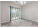 Bright living room featuring gray wood floors and sliding glass doors to the outside at 901 Palomino Pl, Bargersville, IN 46106