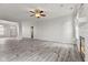 Open living room with hardwood floors, a ceiling fan, and a cozy fireplace at 901 Palomino Pl, Bargersville, IN 46106