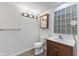 Bathroom featuring a classic vanity, a tiled floor, and a glass block window at 920 E 62Nd St # Apt M7, Indianapolis, IN 46220