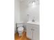 Bathroom featuring a toilet, vanity with sink, and a modern lighting fixture above at 920 E 62Nd St # Apt M7, Indianapolis, IN 46220
