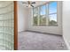 Bedroom featuring large windows, neutral carpet, and a ceiling fan at 920 E 62Nd St # Apt M7, Indianapolis, IN 46220