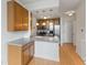 Well-lit kitchen featuring wood cabinets, white countertops, stainless steel appliances, and hardwood floors at 920 E 62Nd St # Apt M7, Indianapolis, IN 46220
