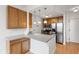 Kitchen with wood cabinets, white countertops, stainless steel appliances, and hardwood floors at 920 E 62Nd St # Apt M7, Indianapolis, IN 46220