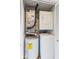 Efficient laundry area with stacked washer and dryer and adjacent water heater, maximizing space at 920 E 62Nd St # Apt M7, Indianapolis, IN 46220