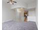 Bright living room featuring neutral walls, a glass block wall, and gray carpet, seamlessly connected to the kitchen at 920 E 62Nd St # Apt M7, Indianapolis, IN 46220