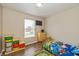 Comfortable bedroom featuring laminate floors, natural light, and colorful toy storage at 9307 W Dockside Cir, Pendleton, IN 46064