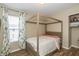 Inviting bedroom featuring a stylish canopy bed, natural light, and hardwood floors at 9307 W Dockside Cir, Pendleton, IN 46064