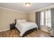 Comfortable bedroom with hardwood floors, queen bed, and decorative curtains at 9307 W Dockside Cir, Pendleton, IN 46064