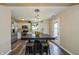 Open dining area with a stylish table, stools, and modern lighting, seamlessly connected to the adjacent kitchen space at 9307 W Dockside Cir, Pendleton, IN 46064