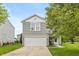 Charming home featuring gray siding, a two-car garage, and a well-manicured front yard with a walkway to the front door at 9307 W Dockside Cir, Pendleton, IN 46064