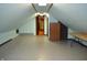 Unfinished attic space with light blue paint, includes wooden beams, with door, and table at 931 Beech Dr, Greenwood, IN 46142